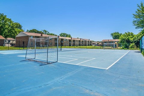 a tennis court with a net in front of a building