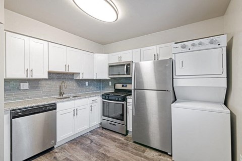 a kitchen with stainless steel appliances and white cabinets