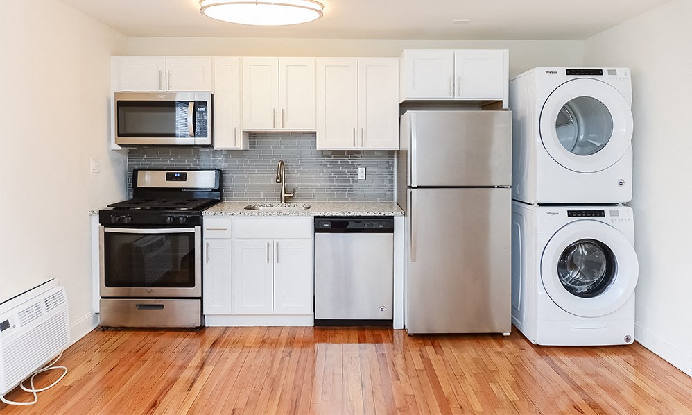 a kitchen with a stove refrigerator and a washing machine
