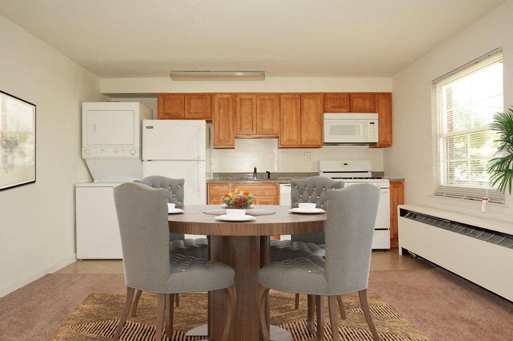 a kitchen and dining room with a table and chairs