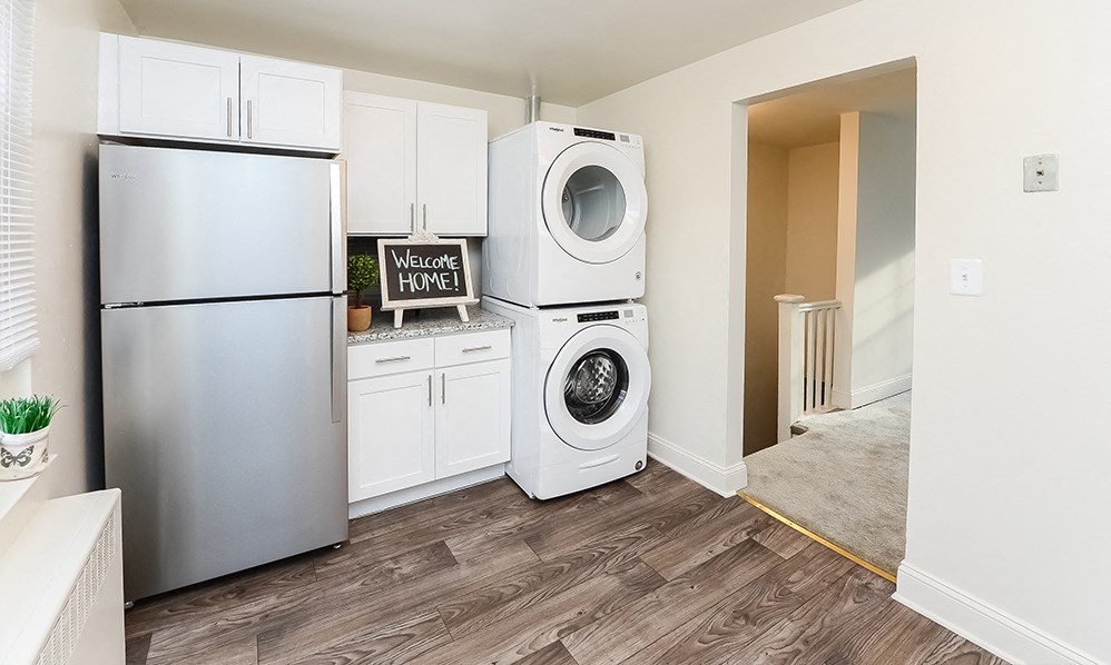 a kitchen with a washing machine and a refrigerator