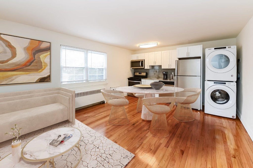 a living room with a table and a washing machine