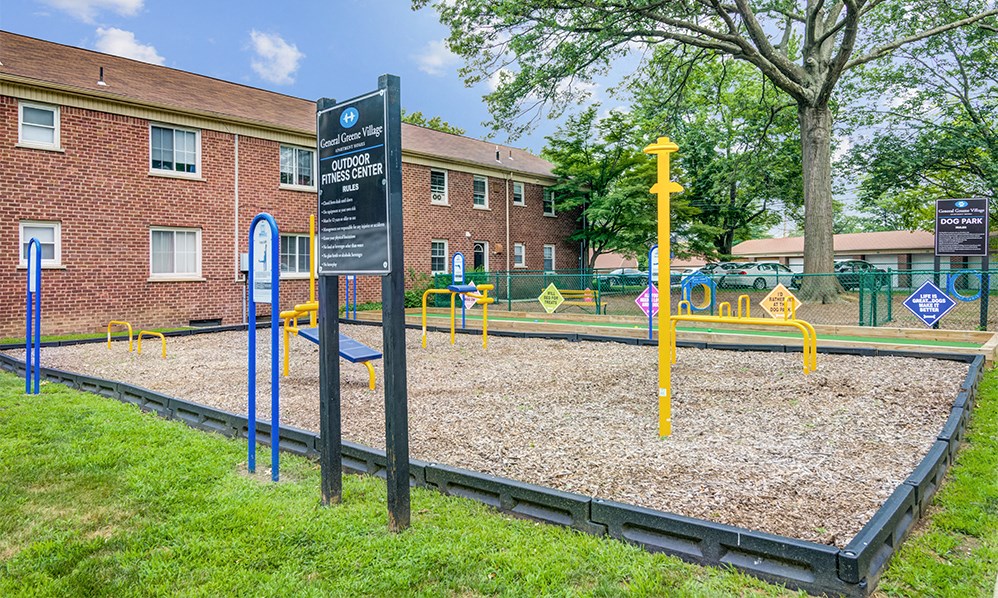 a playground at a school with a sign in front of it