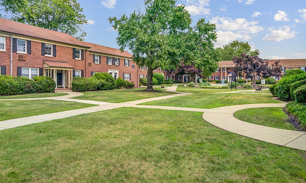 a sidewalk in front of a brick building