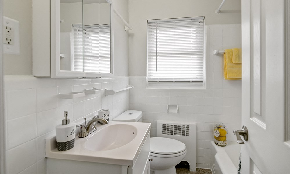 a white bathroom with a sink and a toilet