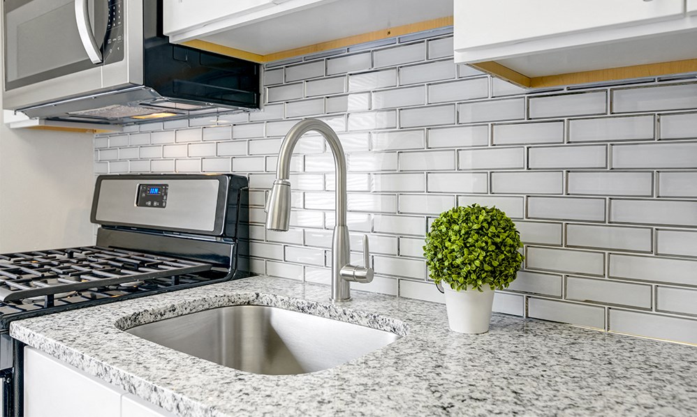 a kitchen with granite counter tops and a sink