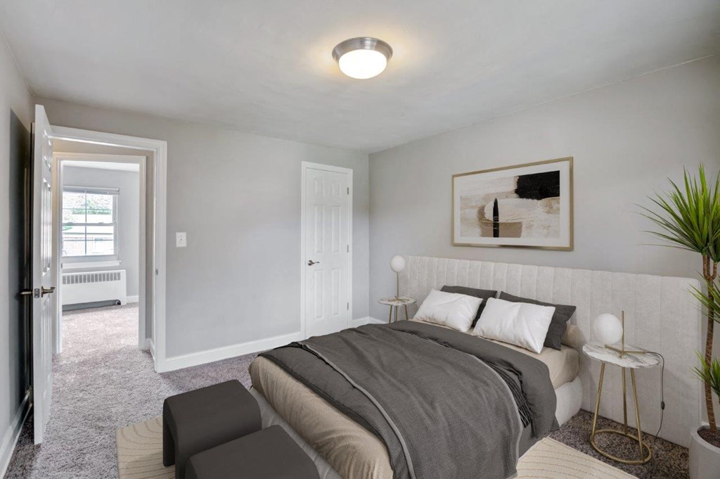 a bedroom with a bed and a door into a room