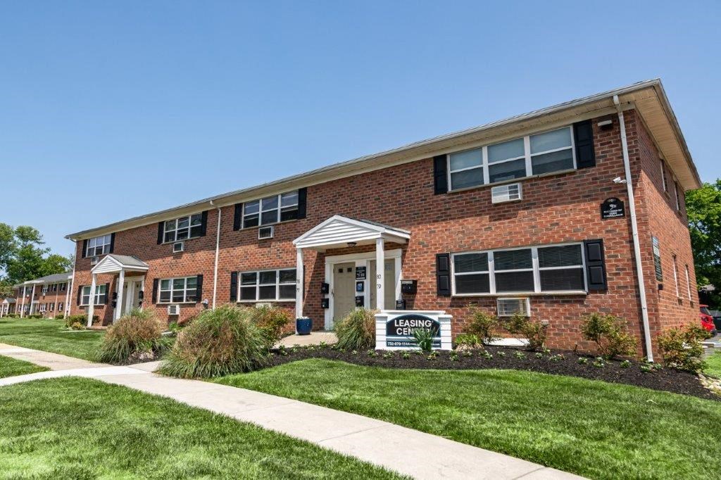 a brick building with a sidewalk in front of it