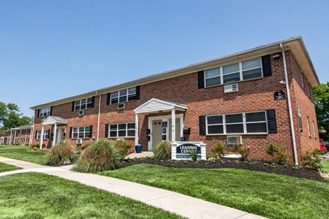 a brick building with a sidewalk in front of it