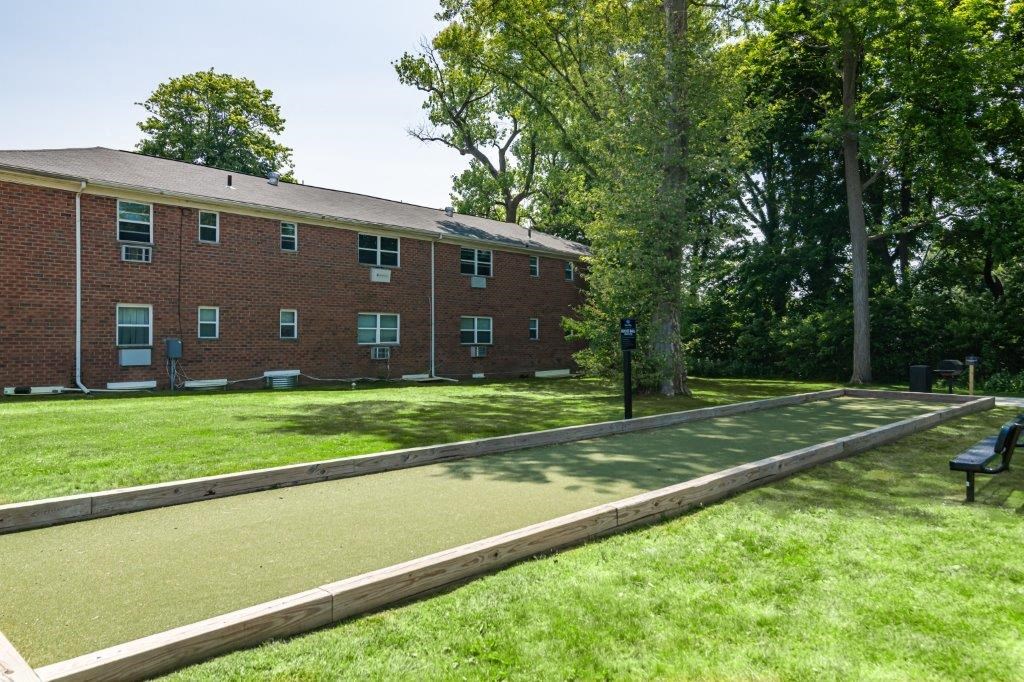 a tennis court in front of a brick building