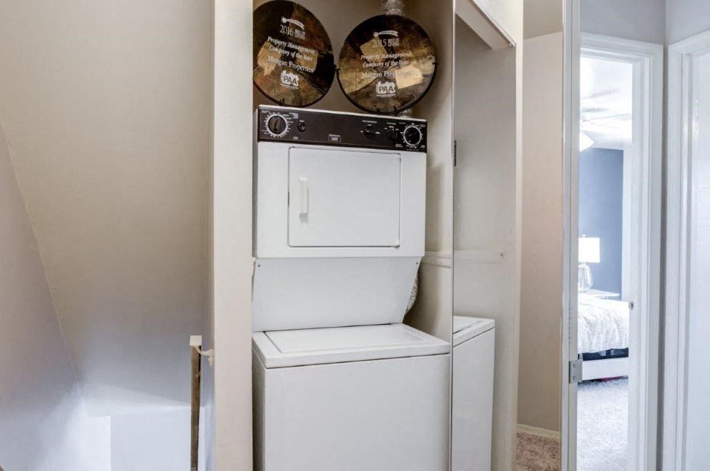 a white washer and dryer in a white closet