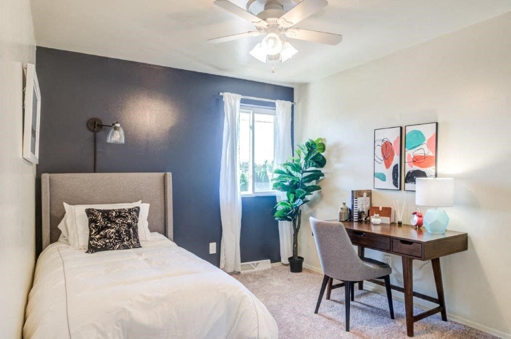 a bedroom with a bed and a desk