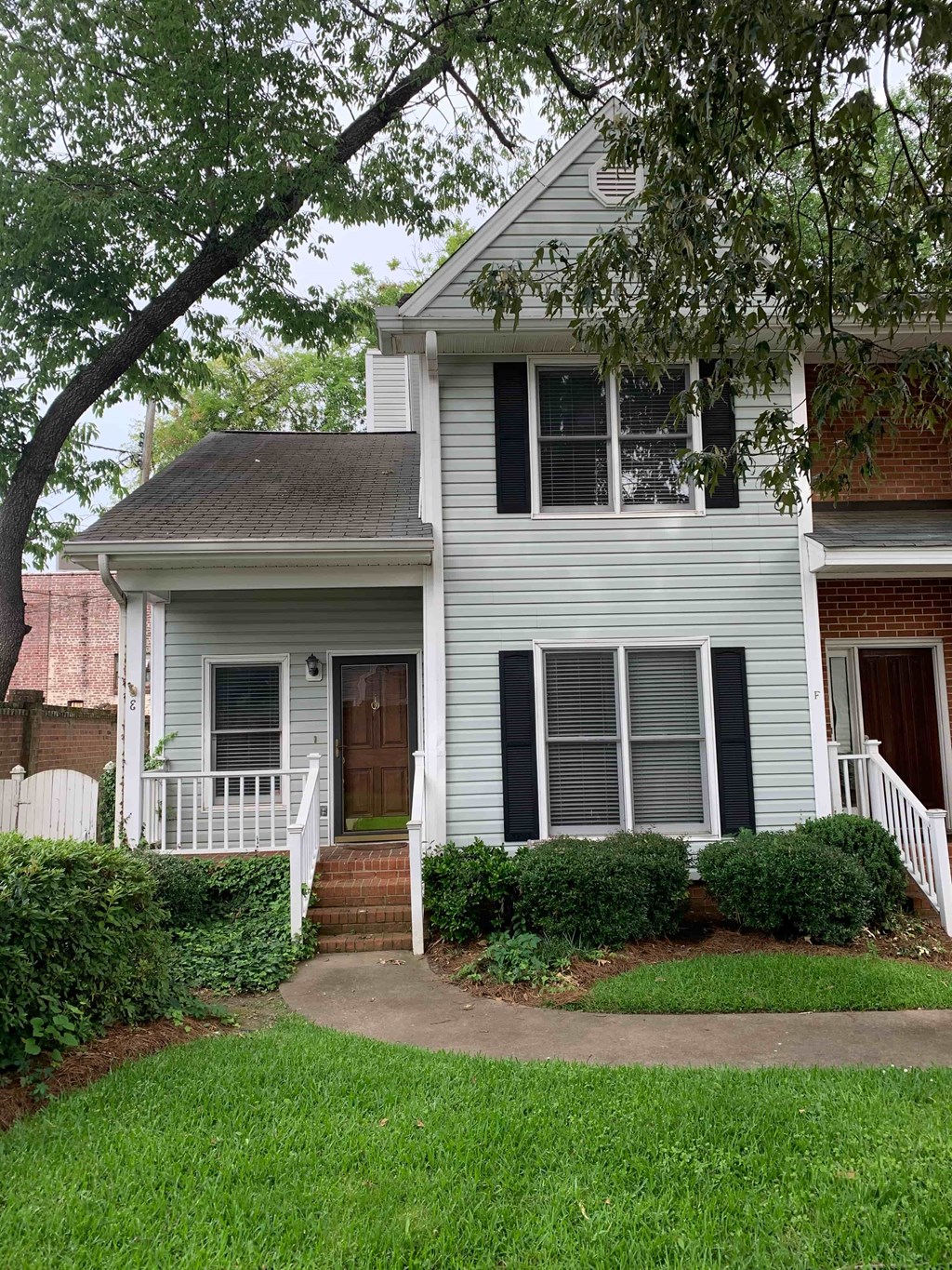 a white house with a sidewalk in front of it