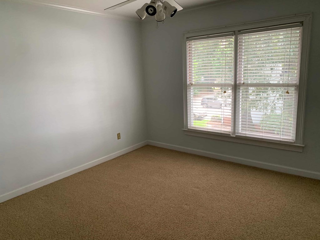 a room with a window and a carpet