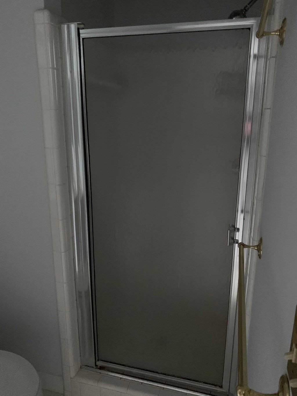 a bathroom with a shower with a glass door