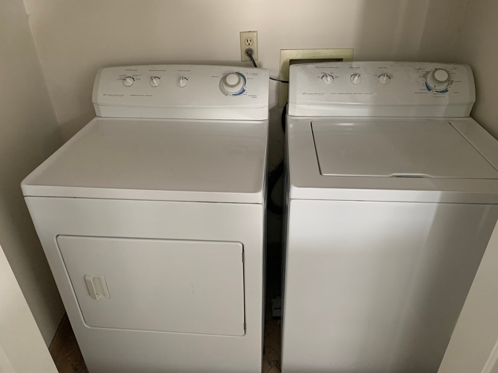two white washers and dryers in a room