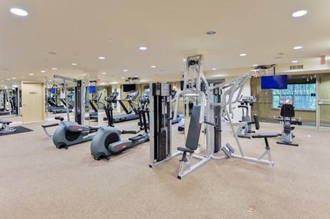 a gym with various exercise equipment in a large room