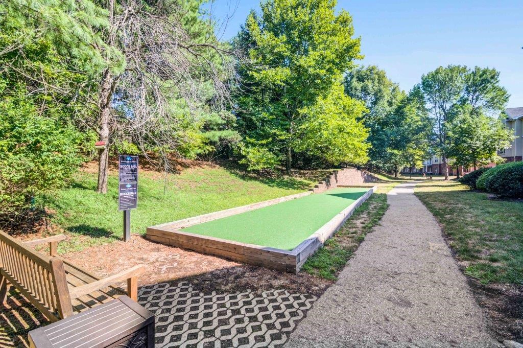 a mini golf course in a park with a path and benches