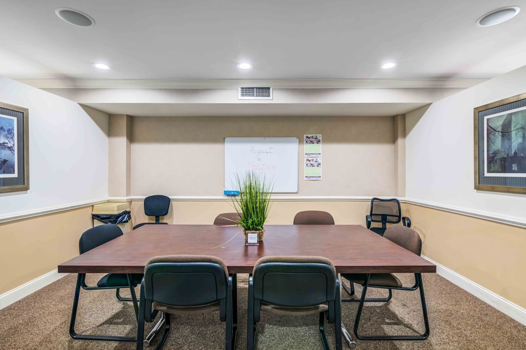 a conference room with a table and chairs