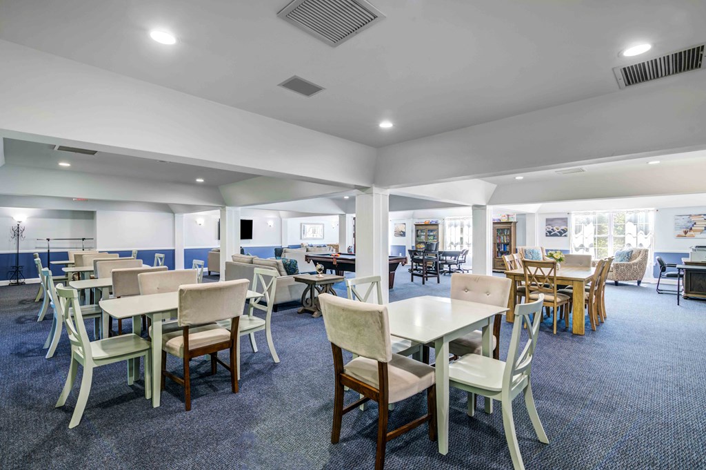 a large dining room with tables and chairs