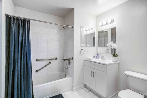 a bathroom with a shower and a sink and a toilet