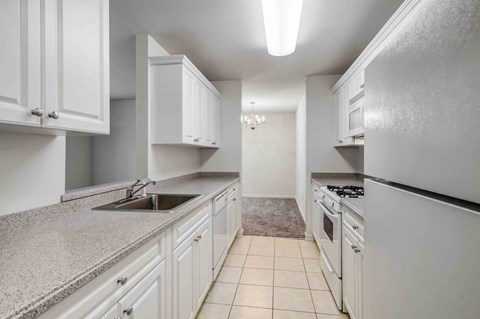 a kitchen with white cabinets and a sink