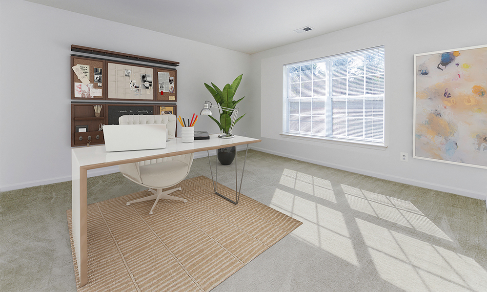 a home office with a desk and a window