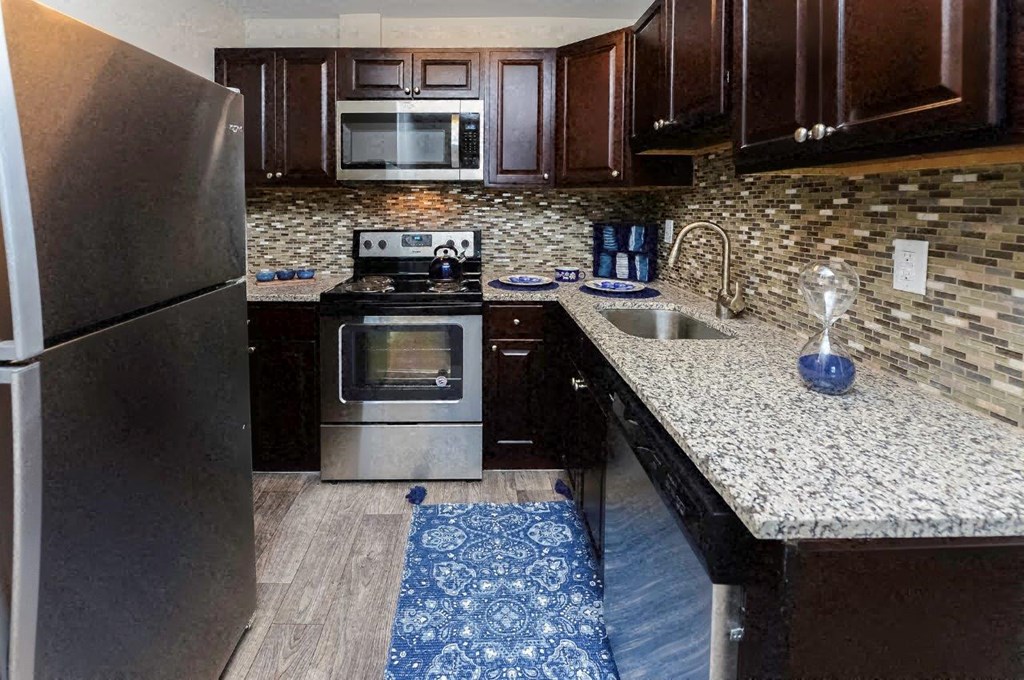 a kitchen with stainless steel appliances and granite counter tops
