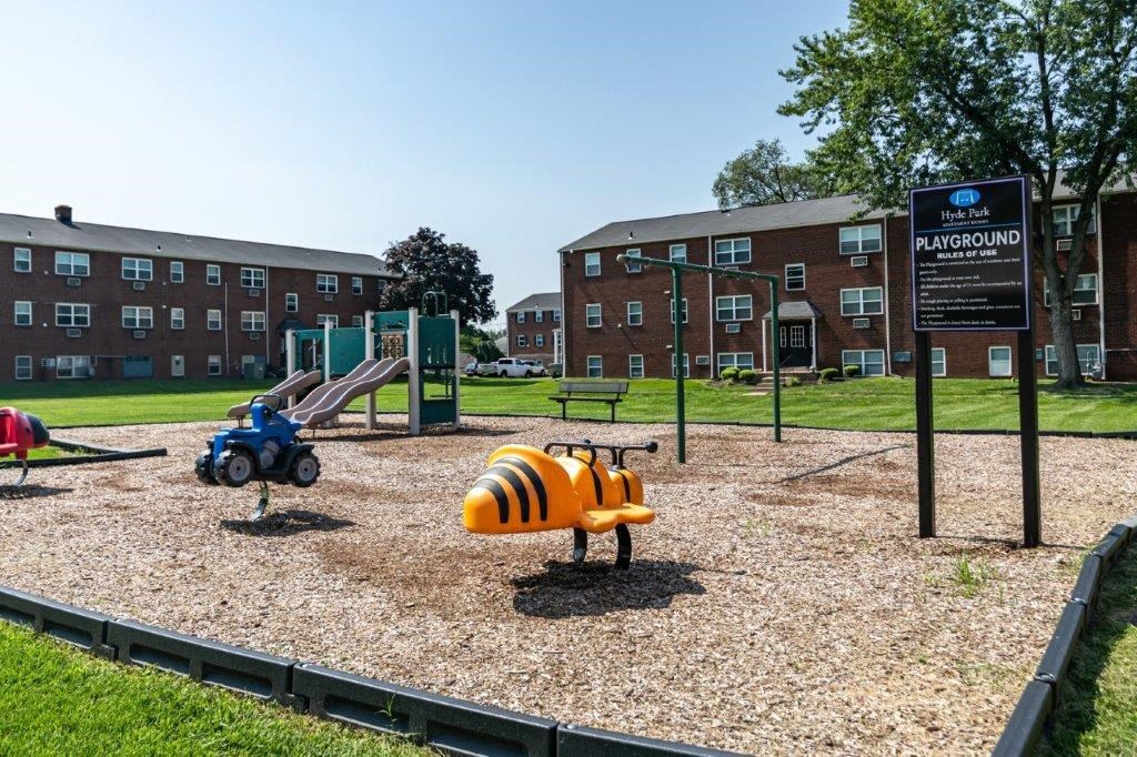a playground in front of an apartment building
