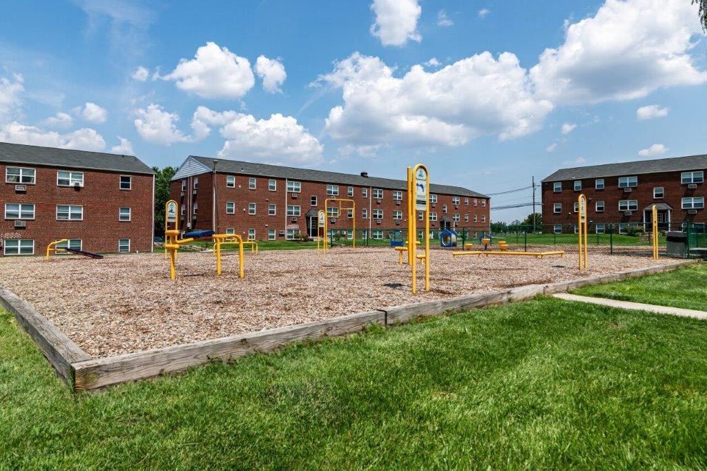 a playground in front of an apartment building