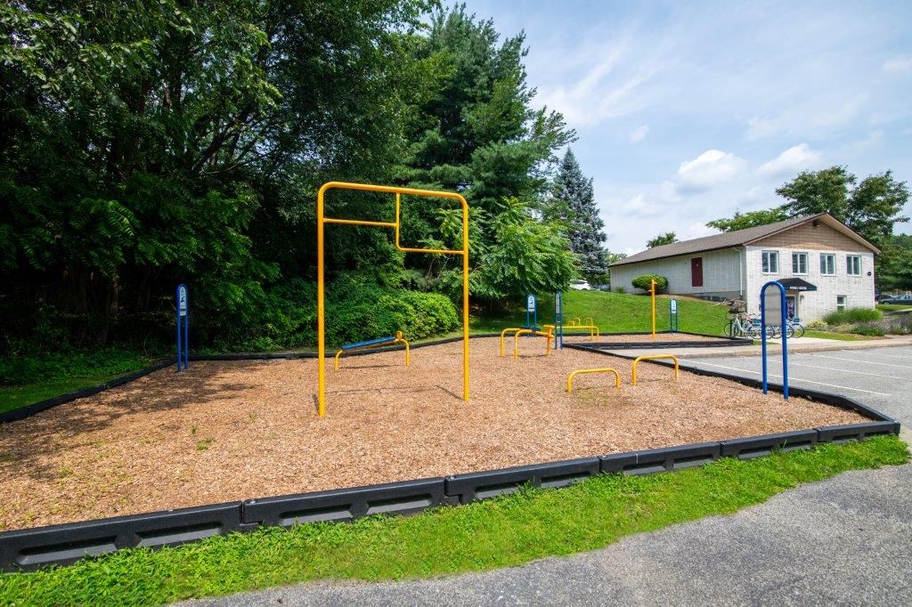 a playground in a park next to a house