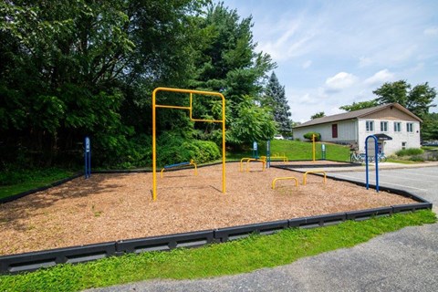 a playground in a park next to a house