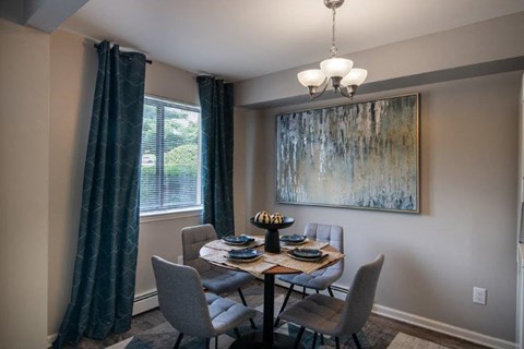 a dining room with a table and chairs