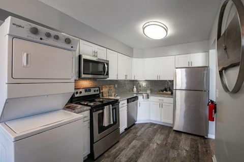 a kitchen with stainless steel appliances and white cabinets