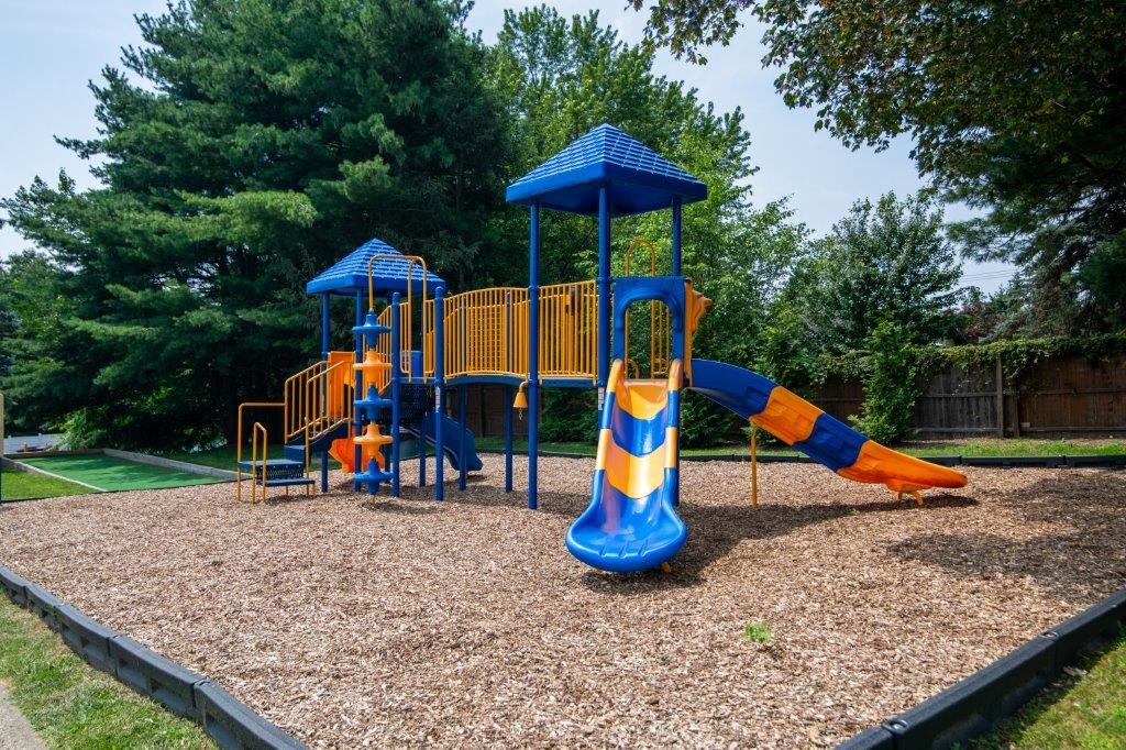 a playground with a slide and other playground equipment