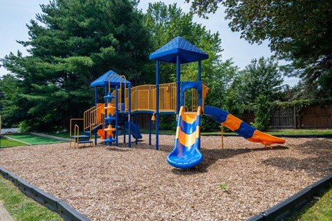 a playground with a slide and other playground equipment