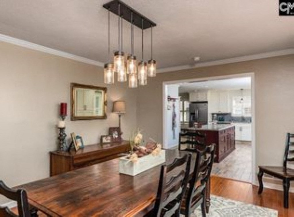 A dining room with a wooden table and chairs.