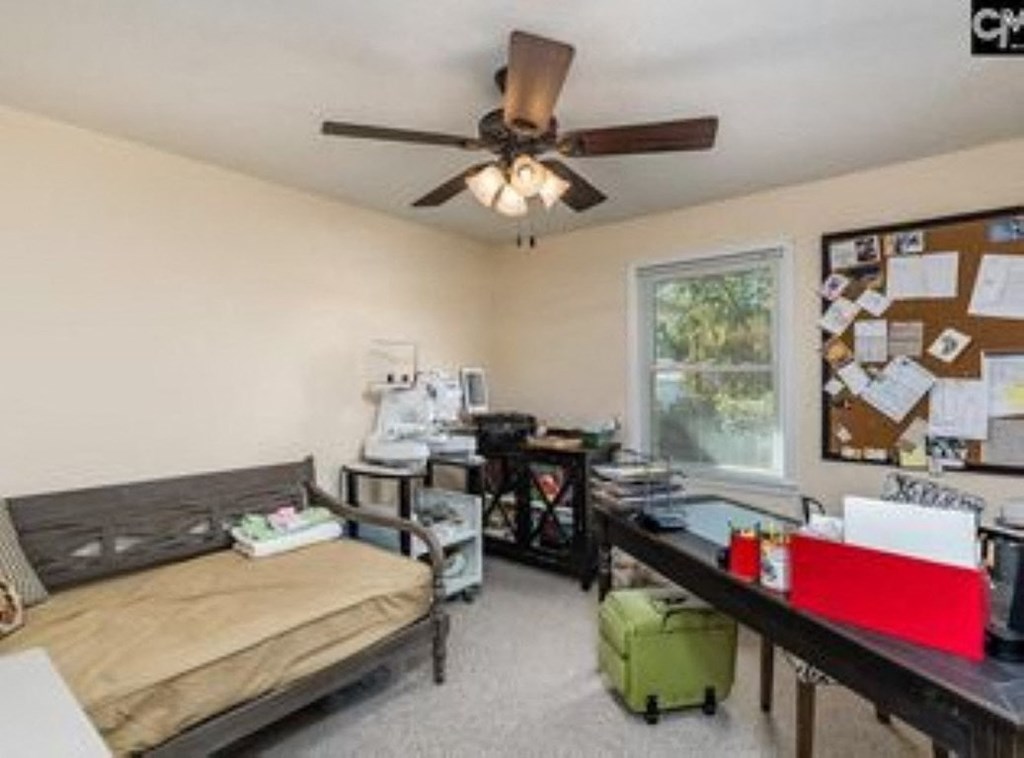 A room with a bed, desk, and a window.