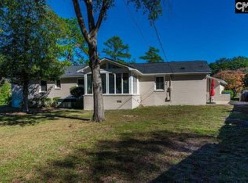 A house with a tree in front of it.