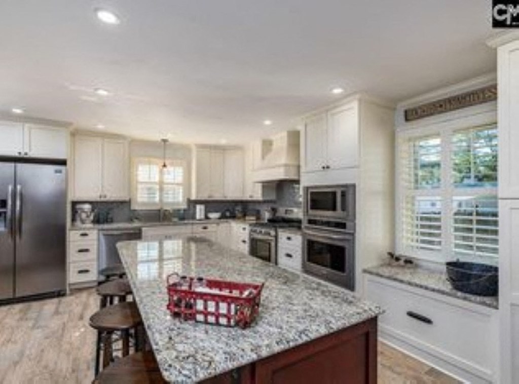 A kitchen with granite countertops and stainless steel appliances.