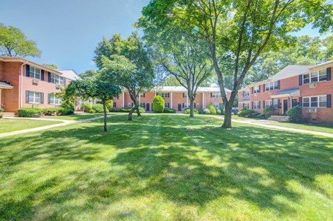 our apartments are located in a quiet neighborhood with green grass and trees