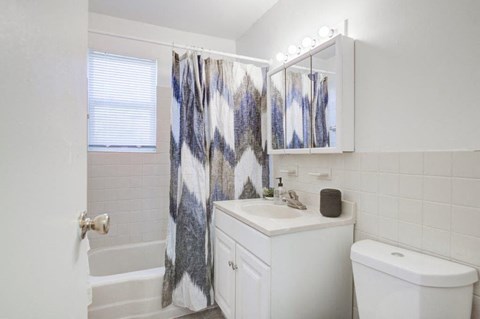 a bathroom with a sink toilet and a shower