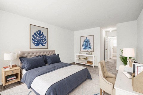 a bedroom with a bed and two paintings on the wall