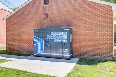 the entrance to theresident package center outside of a brick building