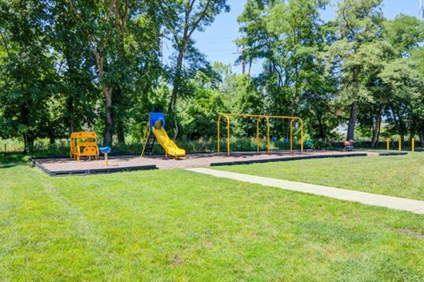 a playground with slides and swings in a park