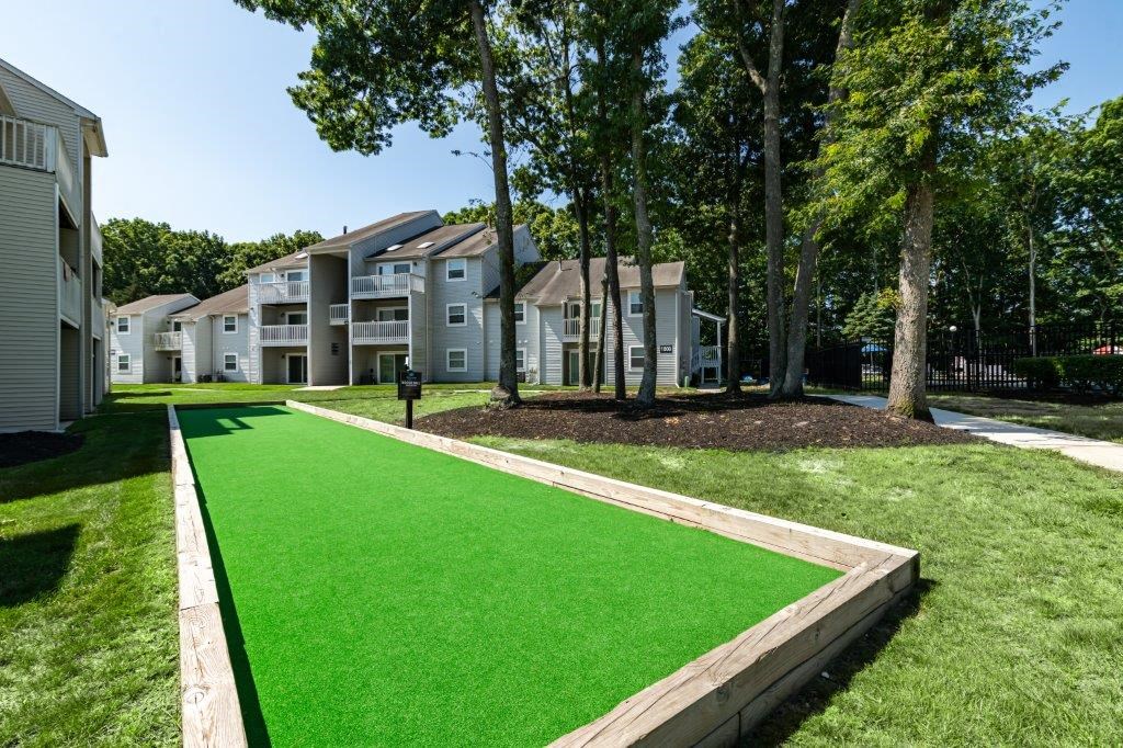a lush green lawn in front of some apartment buildings