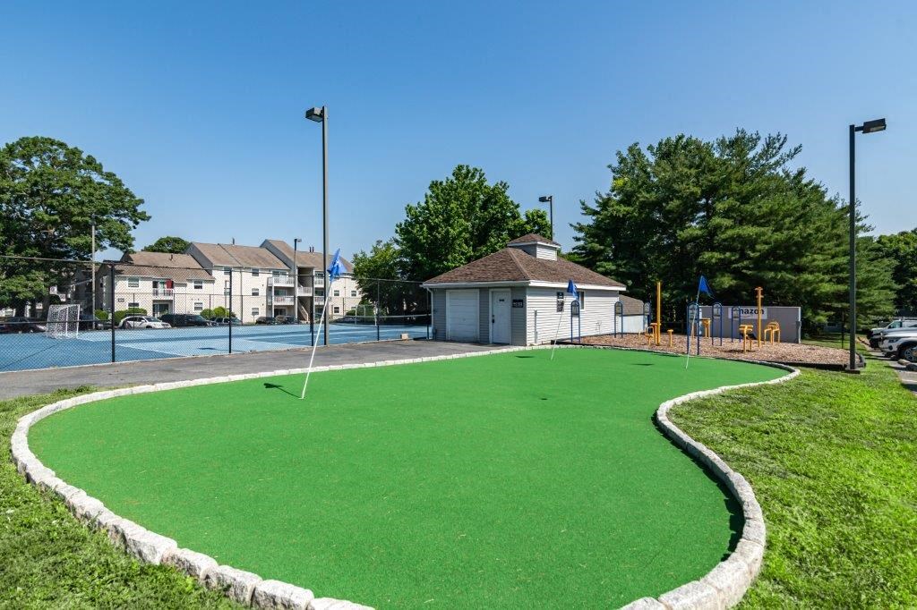a putting green in a park with a pool
