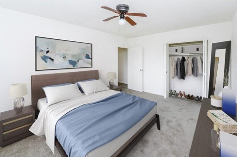 a bedroom with a bed and a ceiling fan