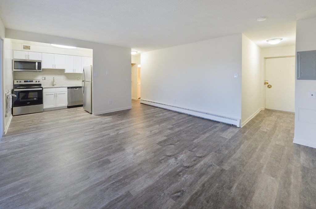 A spacious room with a grey floor and white walls.