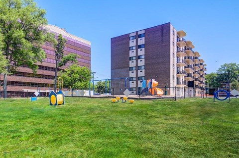 a playground in a park next to some buildings